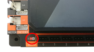 A close-up of a REV Hub's servo ports showing the black, red, and white color-coded wiring symbols.