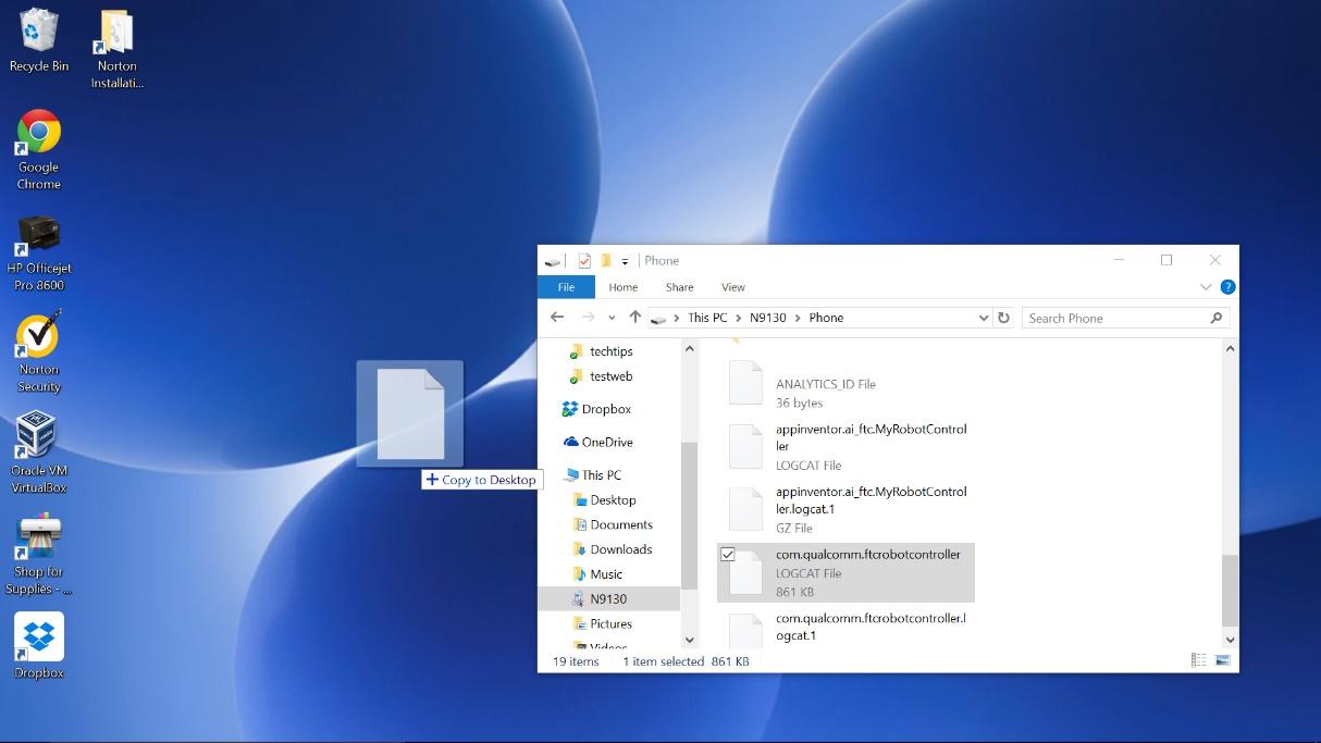 A log file being dragged from File Explorer onto the Windows desktop with a Copy to Desktop tooltip.